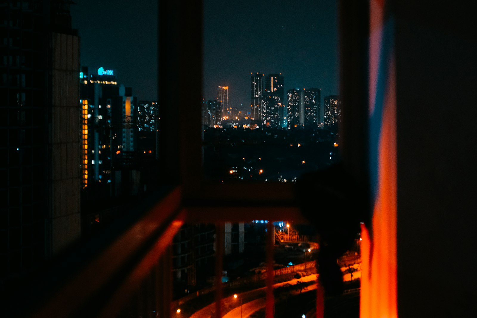 A city skyline at night seen from a window