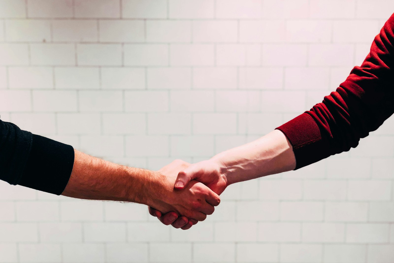 Two people shaking hands at the end of a conversation