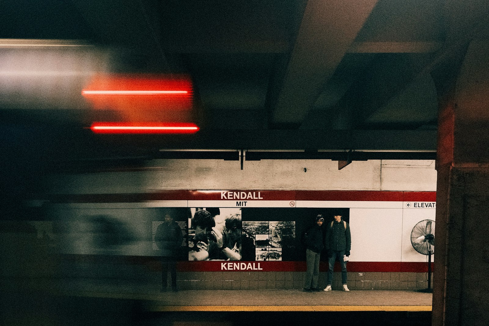 A busy underground platform blurred with movement